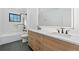 Modern bathroom featuring a double sink vanity, marble counters, and walk-in shower at 715 Glencoe St, Denver, CO 80220