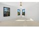 Bright bedroom with neutral carpet, white walls, black trim windows, and a gold ceiling fan at 715 Glencoe St, Denver, CO 80220