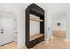 Inviting entryway featuring a custom black storage unit with light wood accents and herringbone floors at 715 Glencoe St, Denver, CO 80220