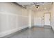 Spacious unfinished garage with sealed concrete floor, and electric door at 715 Glencoe St, Denver, CO 80220