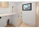 Modern laundry room equipped with marble countertops, custom cabinets, and convenient dog wash station at 715 Glencoe St, Denver, CO 80220