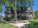 Charming brick apartment building with well-maintained landscaping and mature trees at 309 E Highline Cir # 104, Centennial, CO 80122