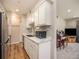 Modern kitchen with white cabinets, stainless steel appliances and view of the living room and piano at 309 E Highline Cir # 104, Centennial, CO 80122