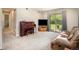 Bright living room featuring plush carpeting, a piano, and sliding glass doors to the backyard at 309 E Highline Cir # 104, Centennial, CO 80122