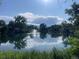 Picturesque view of a serene pond with a fountain and trees, creating a tranquil setting at 309 E Highline Cir # 104, Centennial, CO 80122