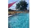 Sparkling pool with lounge chairs and shade sails, perfect for summer relaxation and fun at 309 E Highline Cir # 104, Centennial, CO 80122