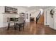 Spacious finished basement with wood floors, bar, and stairway with wooden stairs at 7007 S Garrison St, Littleton, CO 80128
