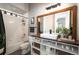 Well-lit bathroom featuring a stylish vanity with modern fixtures and a shower-tub combo at 7007 S Garrison St, Littleton, CO 80128