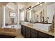 Elegant main bathroom featuring a soaking tub, dual vanities, and classic design at 7007 S Garrison St, Littleton, CO 80128
