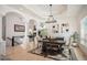 Open dining area with hardwood floors, tray ceiling and neutral walls at 7007 S Garrison St, Littleton, CO 80128