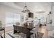 Open-concept dining room with stylish chandelier and views of the kitchen at 7007 S Garrison St, Littleton, CO 80128
