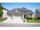 Lovely two-story home with a three car garage and manicured front yard at 7007 S Garrison St, Littleton, CO 80128
