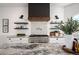 Close-up of kitchen featuring black and white granite countertops and stainless steel appliances at 7007 S Garrison St, Littleton, CO 80128