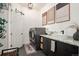 Modern laundry room featuring front load washer/dryer and granite countertop vanity with stylish vessel sink at 7007 S Garrison St, Littleton, CO 80128