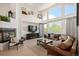 Cozy living room features a fireplace and large windows, with an open and airy atmosphere at 7007 S Garrison St, Littleton, CO 80128