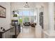 Bright, open living room featuring a fireplace, large windows, and a wine rack at 7007 S Garrison St, Littleton, CO 80128