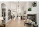 Hallway with wine rack leading to open floor plan and living room fireplace at 7007 S Garrison St, Littleton, CO 80128