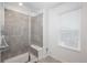Bathroom features a walk-in shower with a glass door and a bench at 3365 N Coolidge Way, Aurora, CO 80019