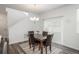 Light-filled dining room features a marble table, chandelier, and sliding glass doors to the exterior at 3365 N Coolidge Way, Aurora, CO 80019