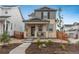 Inviting two-story home with a welcoming front porch and low-maintenance front yard landscaping at 3365 N Coolidge Way, Aurora, CO 80019