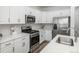 Well-equipped kitchen with white cabinets, stainless steel appliances, and sleek countertops at 3365 N Coolidge Way, Aurora, CO 80019
