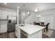 Bright eat-in kitchen features a large island with white quartz countertops and stainless steel appliances at 3365 N Coolidge Way, Aurora, CO 80019