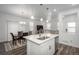 Kitchen features a center island with stainless steel sink and appliances that opens to the dining and living area at 3365 N Coolidge Way, Aurora, CO 80019