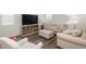 Comfortable living room featuring neutral tones, plush seating, and a modern entertainment center at 3365 N Coolidge Way, Aurora, CO 80019