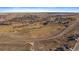 Wide aerial shot showcases a golf course and surrounding residential area, merging recreation and community at 42855 Hawktree Cir, Elizabeth, CO 80107