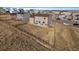 Backyard view of home with patio seating, barbecue, and expansive yard with wood fence at 42855 Hawktree Cir, Elizabeth, CO 80107
