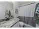 Bathroom with modern fixtures featuring granite countertop, white cabinetry, and a shower with a grey and white curtain at 42855 Hawktree Cir, Elizabeth, CO 80107