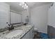 Bathroom featuring double sinks, granite countertops, and shower with gray accents at 42855 Hawktree Cir, Elizabeth, CO 80107