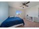 Well-lit bedroom featuring ceiling fan, carpet floors, and natural light from window at 42855 Hawktree Cir, Elizabeth, CO 80107