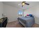 Comfortable bedroom with carpet flooring, ceiling fan with light, and window with neighborhood view at 42855 Hawktree Cir, Elizabeth, CO 80107