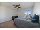 Bright bedroom features neutral walls, carpet flooring, and a ceiling fan with light fixture at 42855 Hawktree Cir, Elizabeth, CO 80107