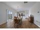 Bright dining area with hardwood floors, adjacent to the kitchen and sliding doors at 42855 Hawktree Cir, Elizabeth, CO 80107