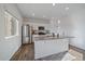 Modern kitchen featuring granite countertops, a stainless steel refrigerator, and an island at 42855 Hawktree Cir, Elizabeth, CO 80107