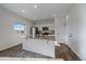 Contemporary kitchen featuring granite countertops, a stainless steel refrigerator, and an island at 42855 Hawktree Cir, Elizabeth, CO 80107