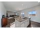 Bright, open kitchen featuring granite countertops and stainless steel appliances flows into the dining and living areas at 42855 Hawktree Cir, Elizabeth, CO 80107