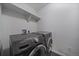 Laundry room featuring sleek, modern, front load, Samsung and LG washing machines and dryer at 42855 Hawktree Cir, Elizabeth, CO 80107