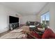 Bright living room with a comfortable sectional sofa and modern entertainment center at 42855 Hawktree Cir, Elizabeth, CO 80107