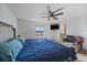 Large main bedroom with a ceiling fan, TV, and ample natural light provides a comfortable and stylish retreat at 42855 Hawktree Cir, Elizabeth, CO 80107