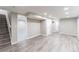 Finished basement with grey wood-look flooring and recessed lighting at 121 Joan Dr, Denver, CO 80221