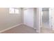 Small bedroom with grey carpet, closet, and access to hallway at 121 Joan Dr, Denver, CO 80221