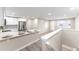 Modern kitchen with white cabinets and quartz countertops at 121 Joan Dr, Denver, CO 80221