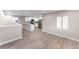 Modern living room with hardwood floors and open concept kitchen at 121 Joan Dr, Denver, CO 80221