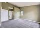 Bedroom featuring neutral walls, carpet, and ensuite bathroom at 7415 S Alkire St # 302, Littleton, CO 80127