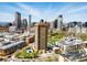 Cityscape panorama featuring a tall apartment building, green spaces, and surrounding neighborhood at 100 Park Ave # 907, Denver, CO 80205