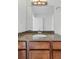 Bathroom featuring a granite countertop, wood vanity, and a large mirror at 100 Park Ave # 907, Denver, CO 80205