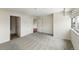 Spacious bedroom with gray carpet, multiple doors, and a large window with natural light at 100 Park Ave # 907, Denver, CO 80205